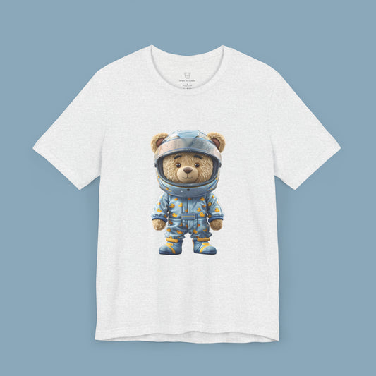 Grip Master teddy bear wearing a light blue karting racing suit with cute rubber duck pattern and light blue helmet on an ash color unisex streetwear t-shirt
