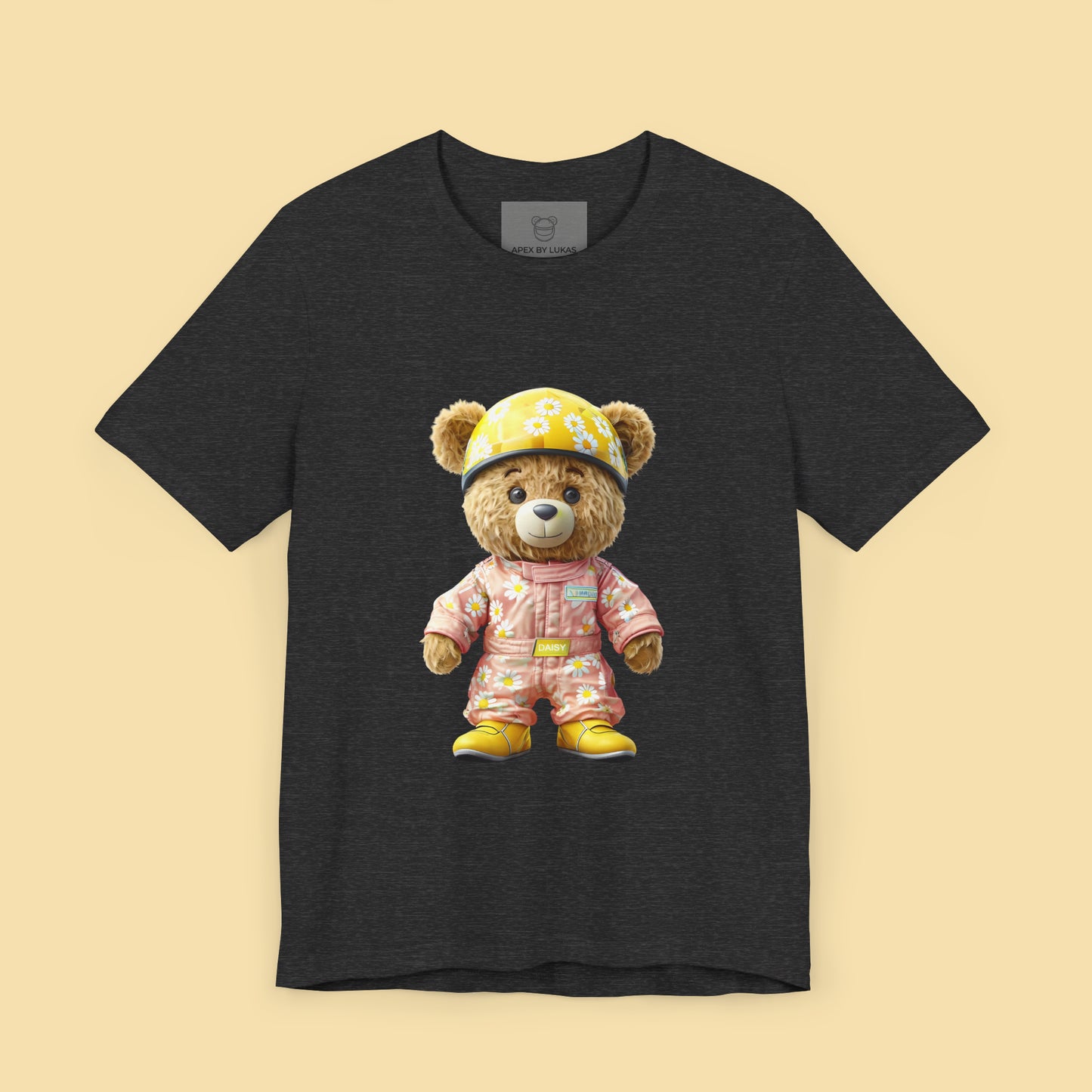 Daisy teddy bear wearing a light pink karting racing suit with daisy floral pattern and yellow helmet on a dark grey heather unisex streetwear t-shirt