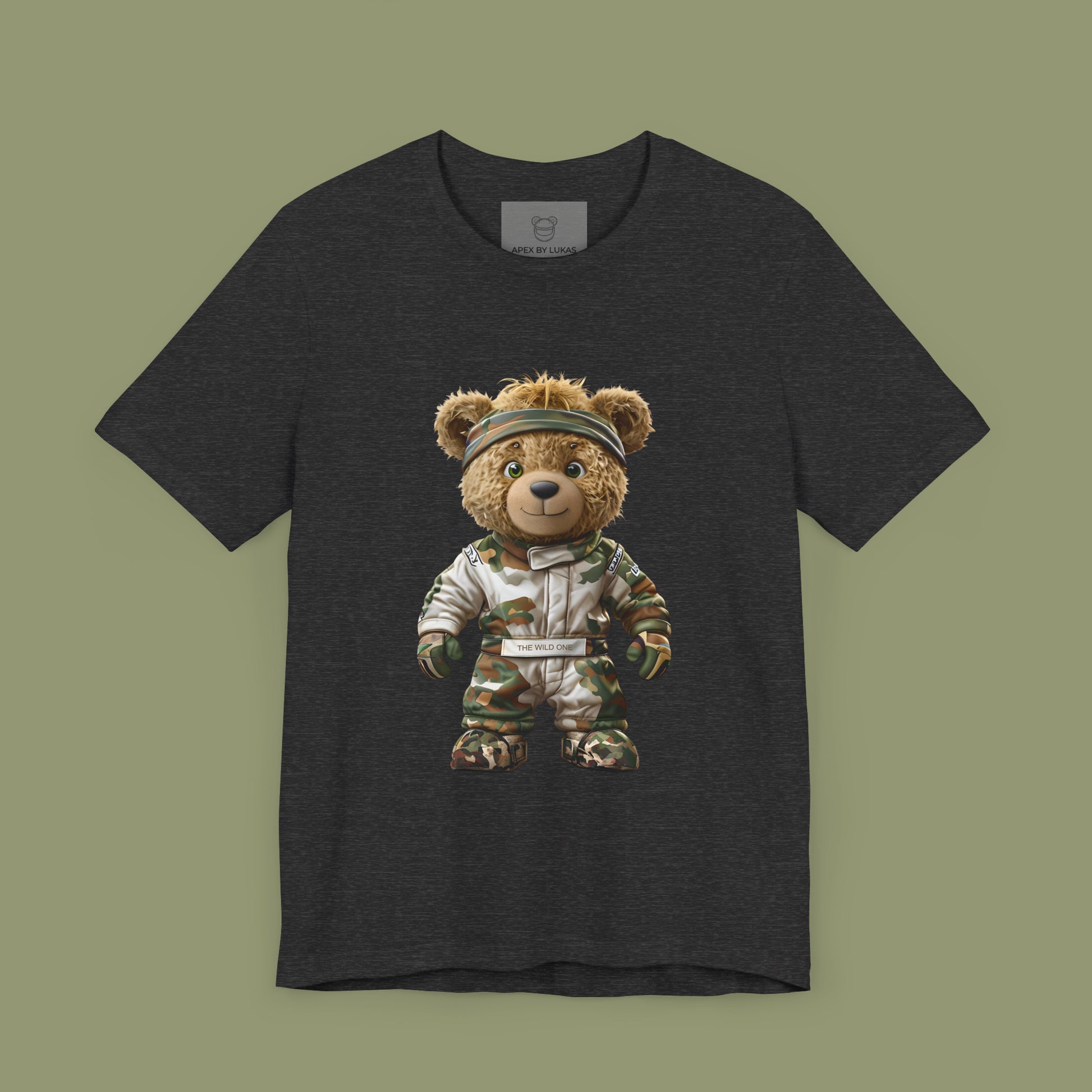 A teddy bear with messy hair wearing a military green racing suit with dirt patches and a bandana on a dark grey heather unisex t-shirt