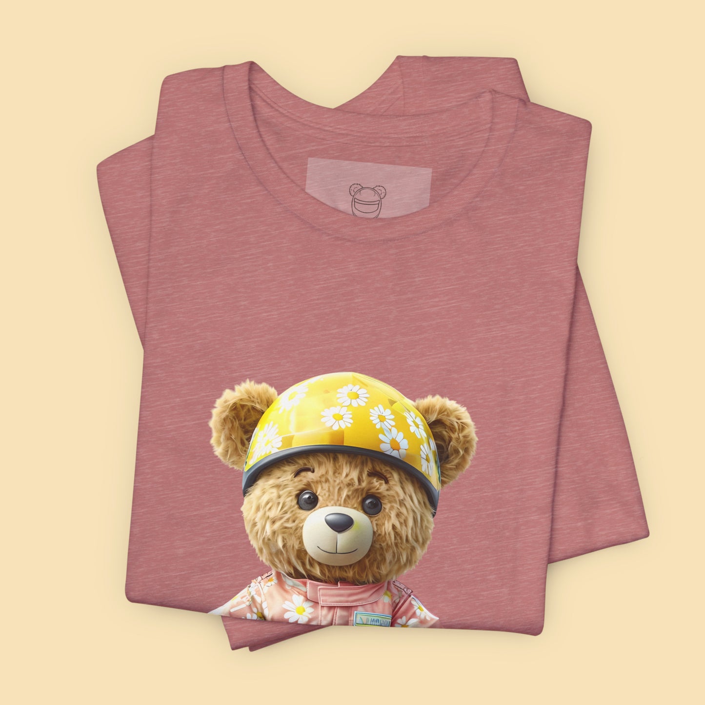 Daisy teddy bear wearing a light pink karting racing suit with daisy floral pattern and yellow helmet on a heather mauve unisex streetwear t-shirt