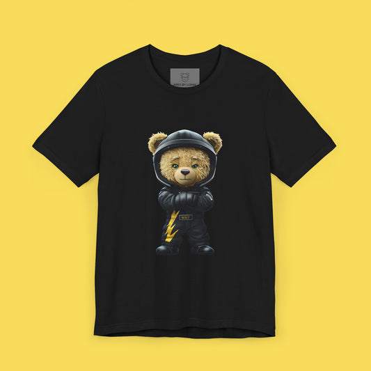 A serious yet cute teddy bear wearing a black karting racing suit with a yellow lightning bolt and a helmet on a black unisex t-shirt