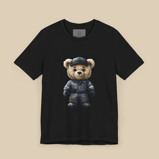 A teddy bear wearing a dark grey, dirty karting racing mechanic suit on a black unisex t-shirt