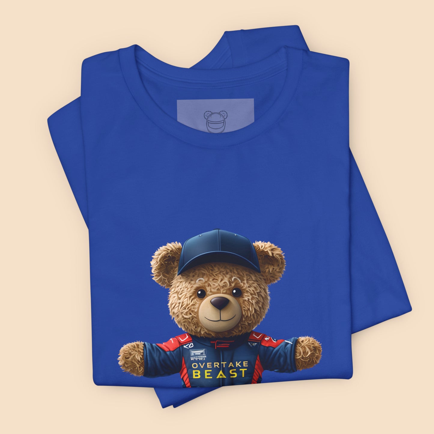 A confident teddy bear wearing Red Bull look a like racing suit and a dark blue cap on a royal blue unisex t-shirt