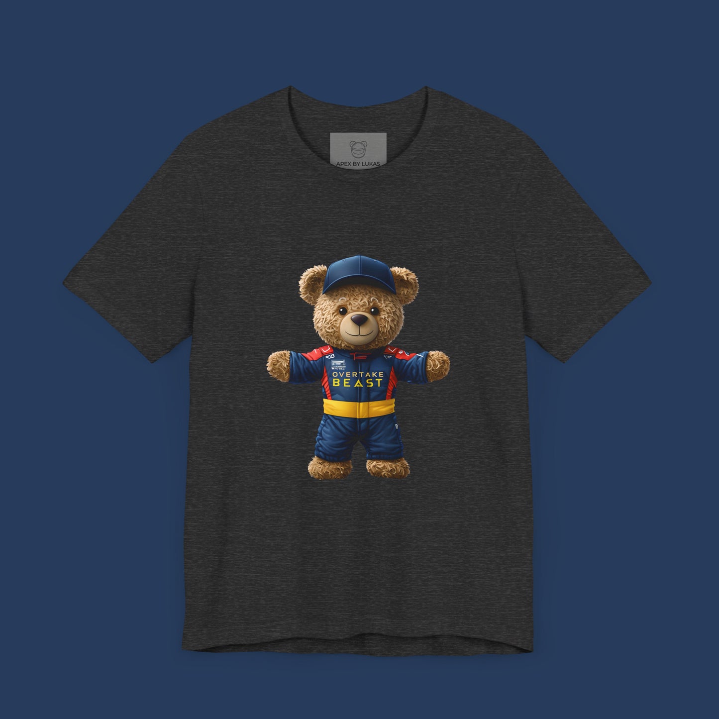 A confident teddy bear wearing Red Bull style racing suit and a dark blue cap on a dark grey heather unisex t-shirt