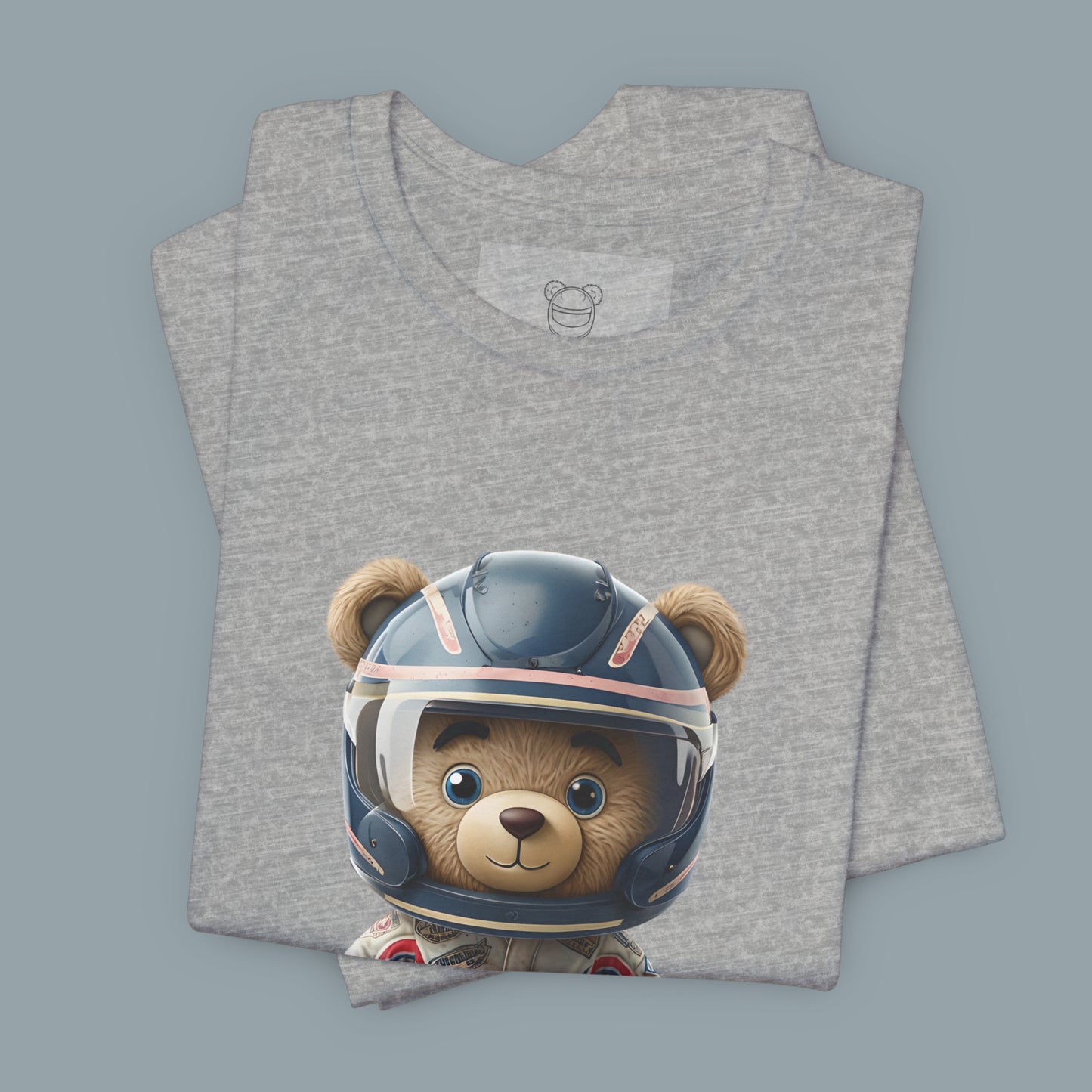 A teddy bear wearing vintage retro beige karting racing suit with red, blue accents and dirt patches and blue helmet on a unisex heather athletic t-shirt