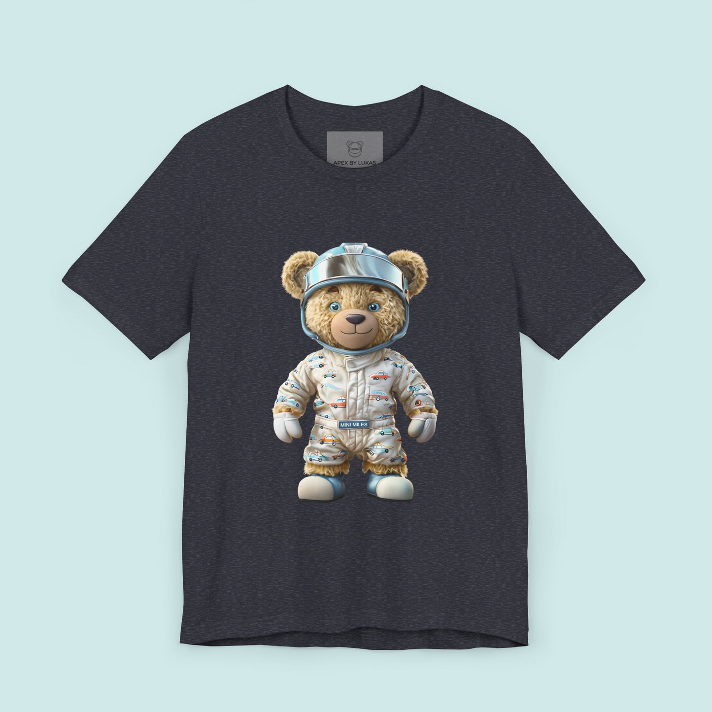 A teddy bear wearing beige karting racing suit with cute car pattern and helmet with chrome visor on a heather navy t-shirt