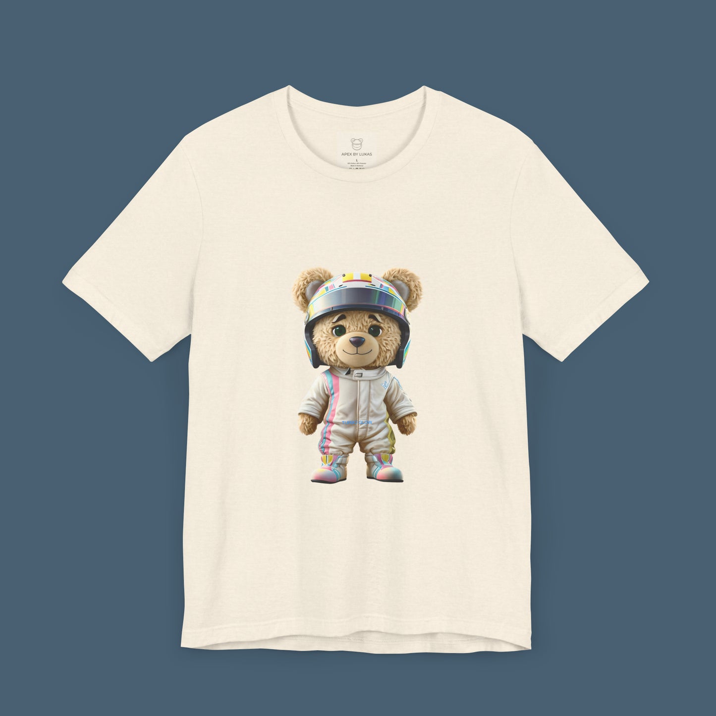 Teddy bear wearing a karting racing suit in beige color with light pink and blue lines on the side and a helmet on a natural color t-shirt