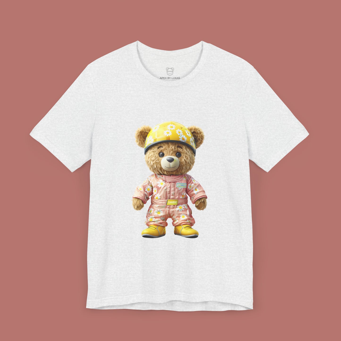 Daisy teddy bear wearing a light pink karting racing suit with daisy floral pattern and yellow helmet on an ash unisex streetwear t-shirt