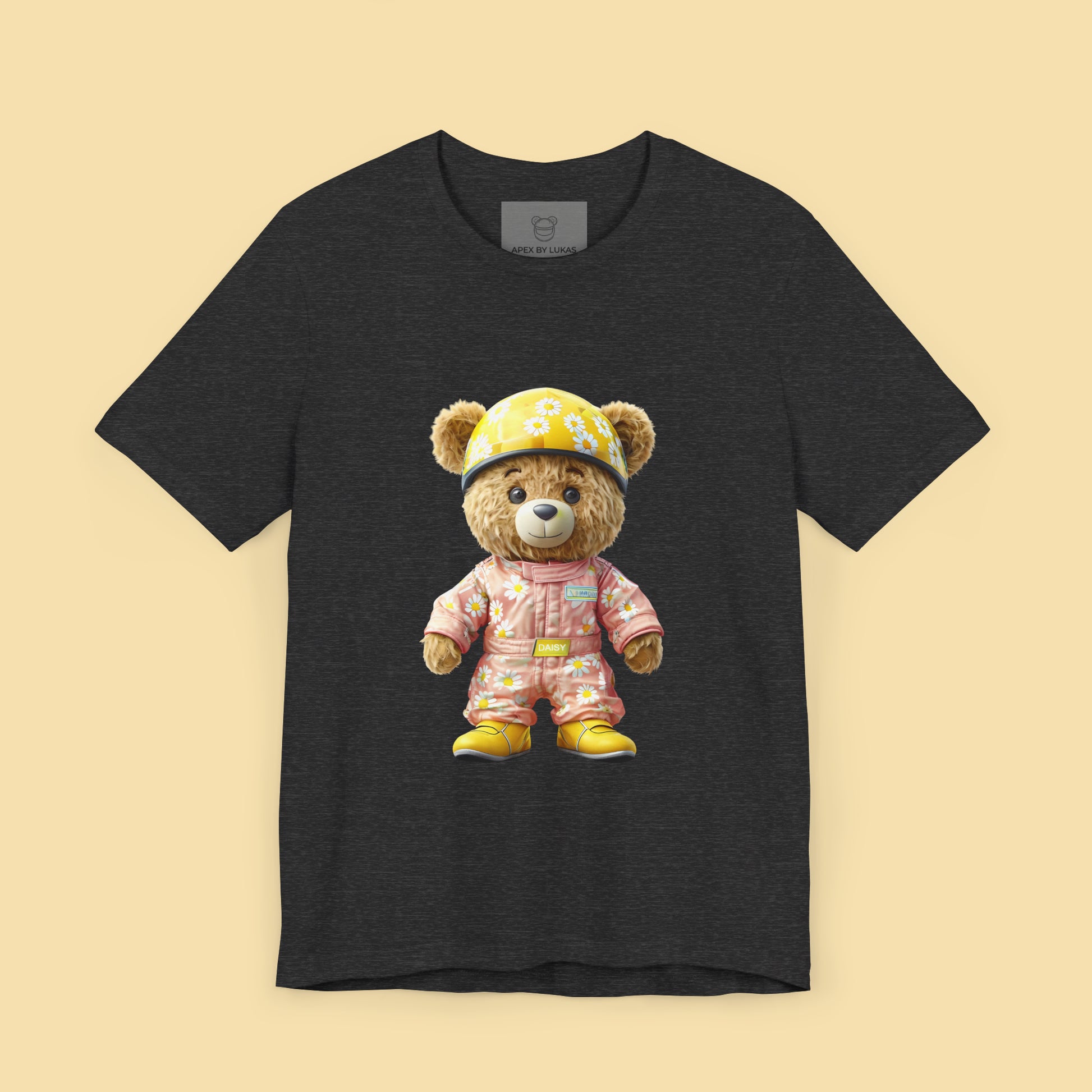 Daisy teddy bear wearing a light pink karting racing suit with daisy floral pattern and yellow helmet on a dark grey heather unisex streetwear t-shirt