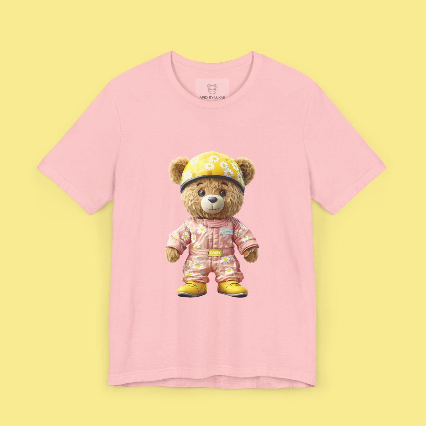 Daisy teddy bear wearing a light pink karting racing suit with daisy floral pattern and yellow helmet on a pink unisex streetwear t-shirt