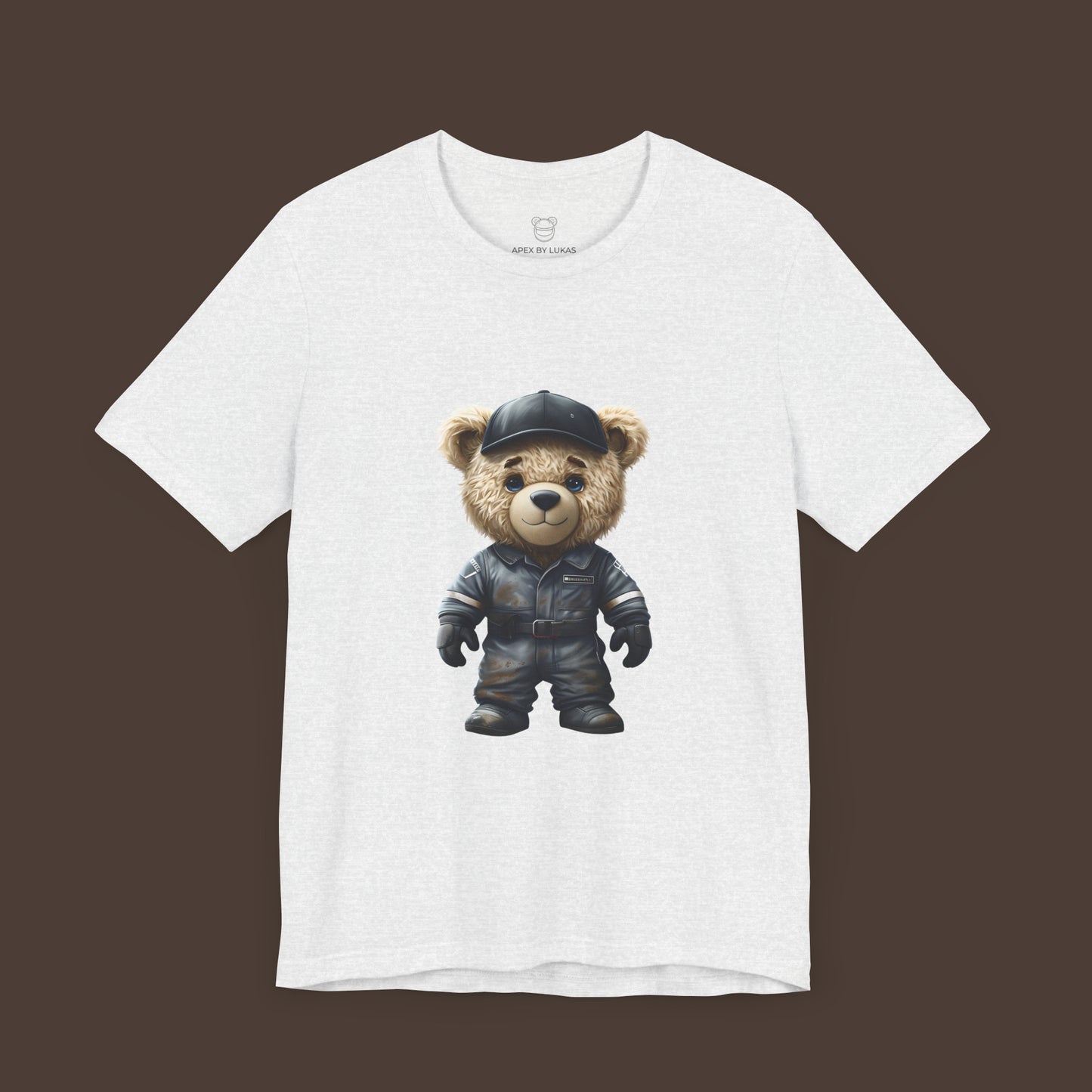 A teddy bear wearing a dark grey, dirty karting racing mechanic suit on an ash unisex t-shirt