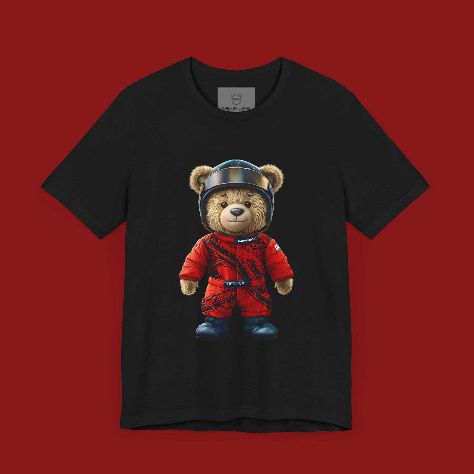 A teddy bear wearing a red karting racing suit with tyre marks, helmet and name patch "Redline" on a black streetwear t-shirt