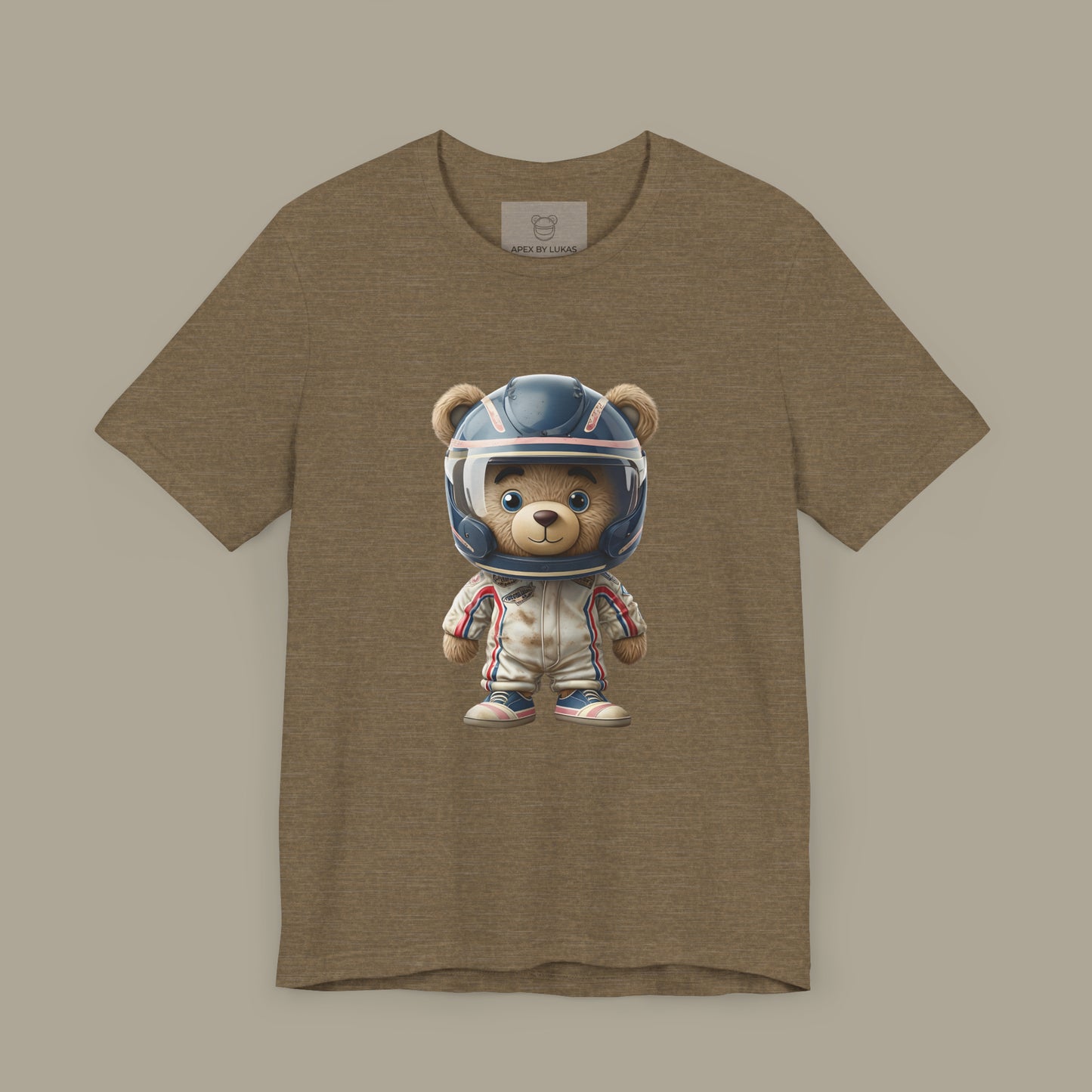 A teddy bear wearing vintage retro beige karting racing suit with red, blue accents and dirt patches and blue helmet on a unisex olive color t-shirt
