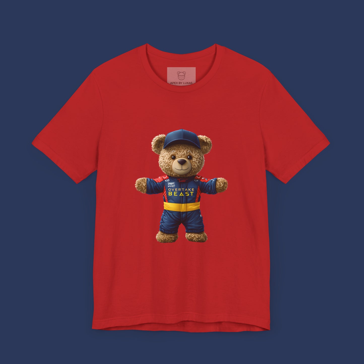 A confident teddy bear wearing Red Bull style racing suit and a dark blue cap on a red unisex t-shirt