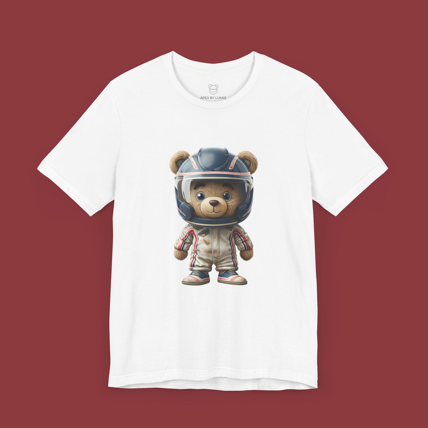 A teddy bear wearing vintage retro beige karting racing suit with red, blue accents and dirt patches and blue helmet on a unisex white t-shirt